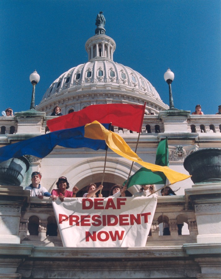 Gallaudet University students protest with signs and banners for a deaf president.